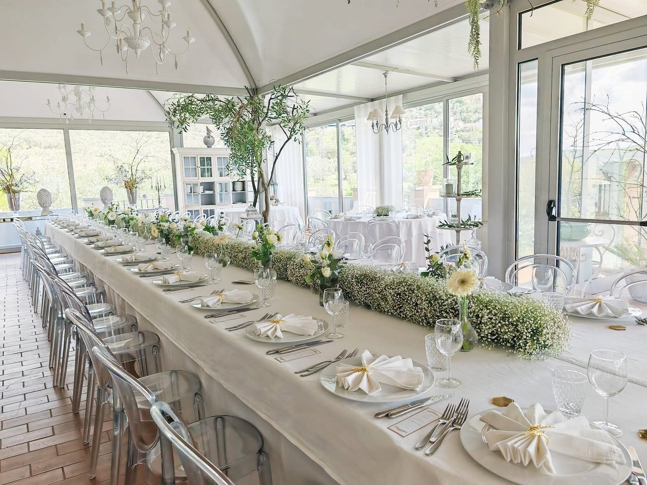 Tavola evento in location luminosa a Catanzaro con allestimento floreale