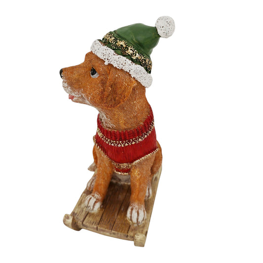 Cagnolino d'appoggio su slitta verde